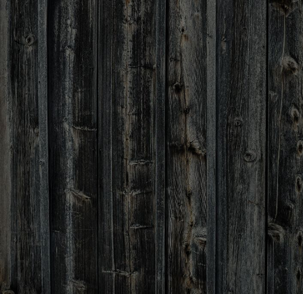 Donkere houten gevelbekleding met natuurlijke houtstructuur als achtergrond..jpg